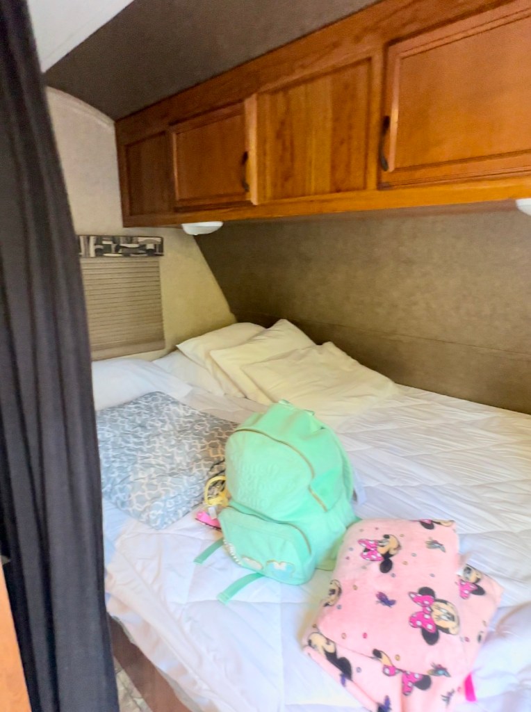 Bed inside our 21’ Bunkhouse rental from RV Share at the Campsites at Disney's Fort Wilderness Resort