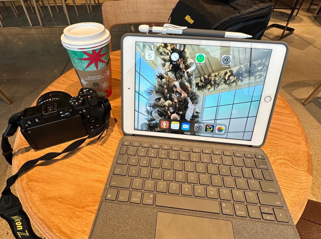 digital nomad set up with computer and camera on table