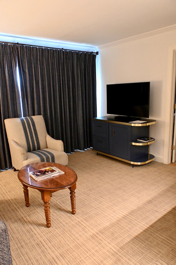 chair and TV inside of the King Vista suite at the Tides Inn in Irvington, Virginia