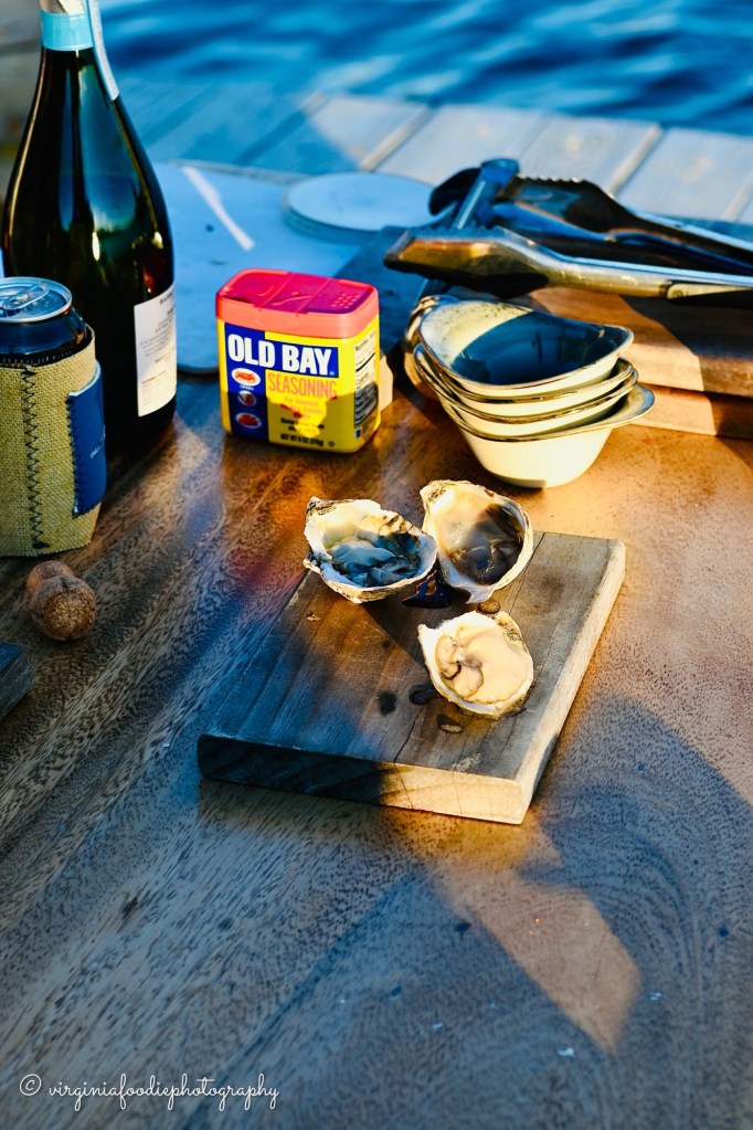 fresh shucked oysters on a board sit with old bay