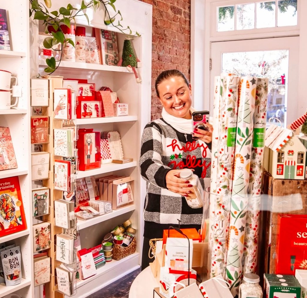 theVirginiahypegirl shops in duly noted in downtown Fredericksburg holding a Christmas item