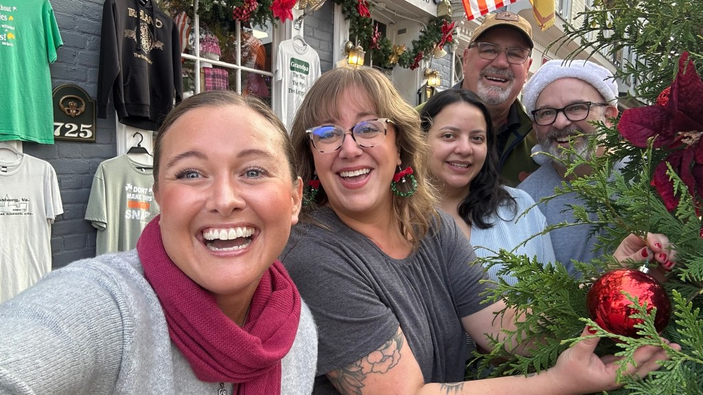 Five members of the Fredericksburg downtown decorate a Christmas tree on Caroline Street